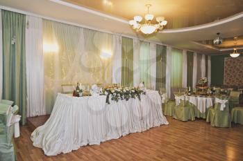 The hall is decorated with flowers and cloth.