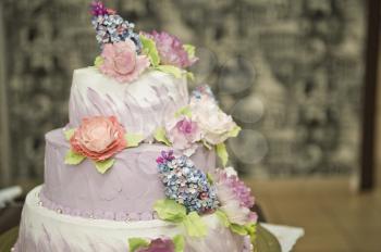 Wedding cake and colorful flowers.