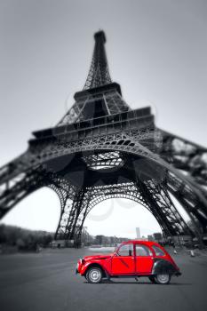 summer sunset vintage red car stands on the Champ de Mars. Eiffel Tower