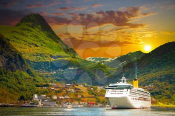 Ferry in Geiranger. bay in the Norwegian mountains. Gold autumn