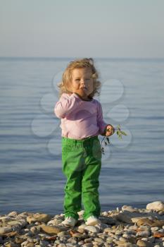 Girl in the autumn at the sea . standing against the evening sea