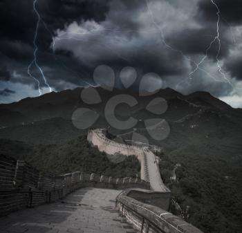 Heavy thunderstorm with lightning. View of the great Chinese wall and mountains.