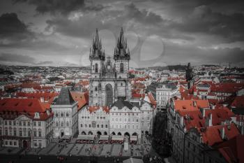 Prague Old town square, Tyn Cathedral. under sunlight. black and white photo with red color.
