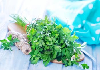 parsley on wooden board and on a table