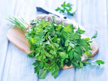 parsley on wooden board and on a table