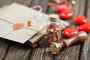 envelopes and red hearts on the wooden table