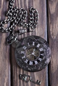 Vintage pocket watch and hour glass or sand timer, symbols of time with copy space