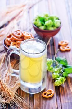 fresh beer in glass on the wooden table