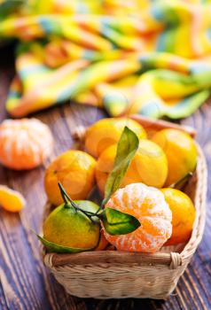 tangerines in basket and on a table