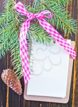 note and brunch of christmas tree on wooden table