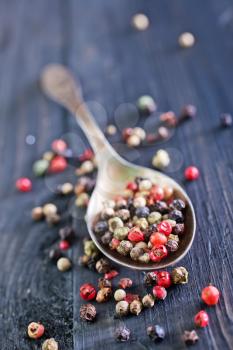 pepper mix in metal spoon and on a table