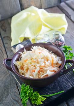 sauerkraut salad in the bowl and on a table