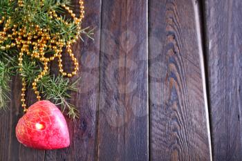 One red candle on the wooden table