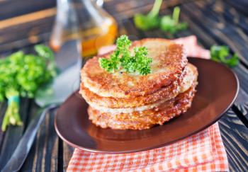 potato pancakes on plate and on a table