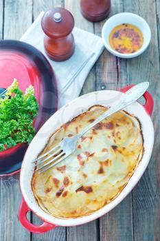 potato gratin in bowl and on a table