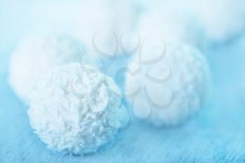 coconut balls with cream on the white table