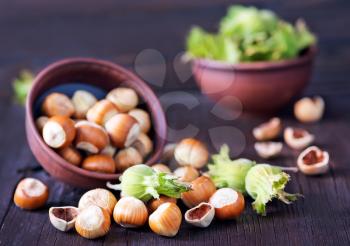 fresh hazelnuts in bowl and on a table