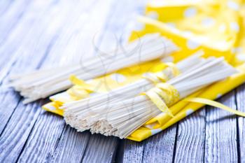 raw rice noodles on yellow napkin and on a table