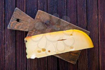 piece of cheese on the wooden table