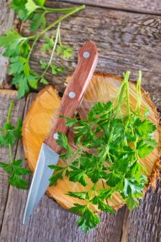 fresh parsley on wooden board and on a table