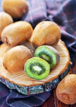 fresh kiwi on wooden board and on a table