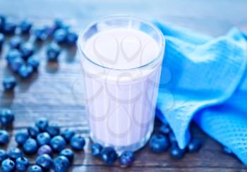 blueberry yogurt in glass and on a table