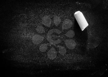 black board and white chalk on a table