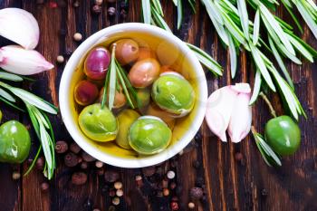 green olives and olive oil with aroma spice