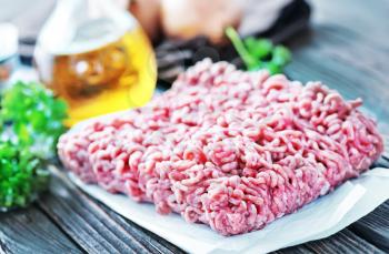 raw minced meat on the wooden board