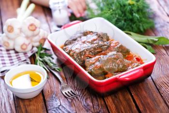 dolma with sauce in the bowl and on a table