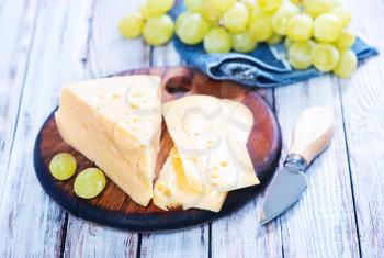 cheese with grape on the wooden table