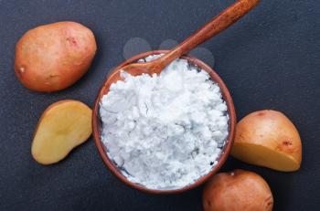 potato starch in bowl and on a table
