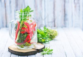 fresh vegetable salad in glass and on a table