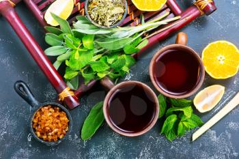 fresh tea in cups and on a table