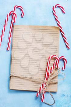 christmas background, book for recipe and candycanes