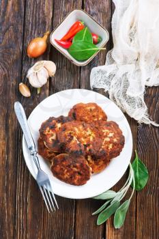 cutlets on white plate and on a table