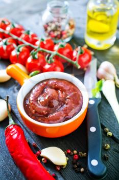 tomato sauce and fresh tomato on a table