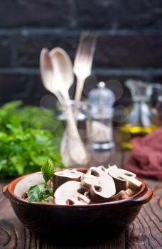 raw mushroom in bowl and on a table