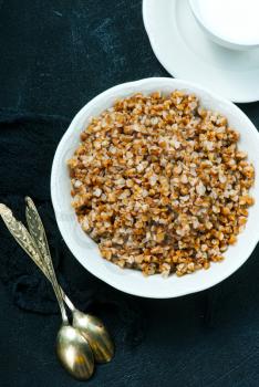 boiled buckwheat in bowl and on a table