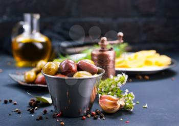 olives with spice in metal bowl and on a table