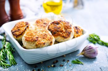 chicken cutlets in white bowl and on a table