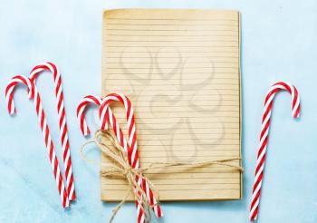 christmas background, book for recipe and candycanes