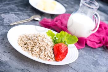 oat flakes with strawberry on white plate