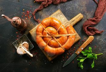 sausages on wooden board and on a table