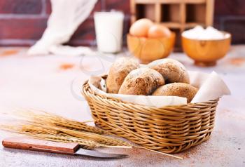 fresh bread in basket and on a table