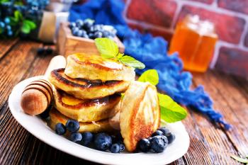 pancakes with blueberry on the plate and on a table