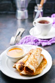 sweet crepes with honey,pancakes on the plate