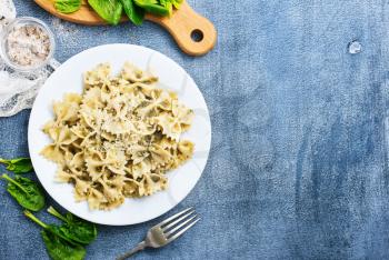 pasta with green sauce, pasta on white plate, stock photo