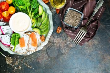 bread with salmon and fresh vegetables on plate