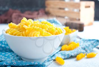 raw pasta in bowl, egg pasta in white bowl